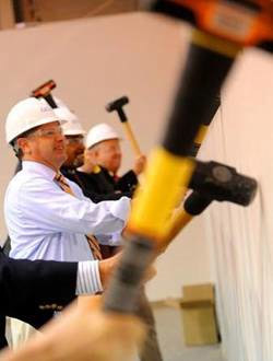 John Fernandez, left, the U.S. Assistant Secretary of Commerce for Economic Development, along with members of Georgia Tech and its partner organizations, participate in a wall breaking to formally kick-off construction and renovation of the facility that will house the Global Center for Medical Innovation (GCMI), the Southeast's first comprehensive medical device innovation center on Tuesday, Aug. 2, 2011. Credit: Jonathan Phillips 
