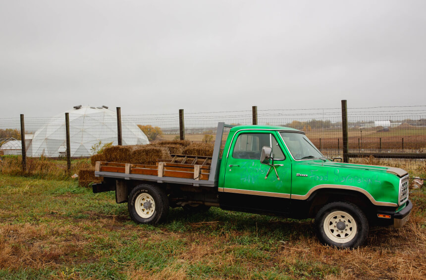 A green truck that has "food sovereignty" painted on the side