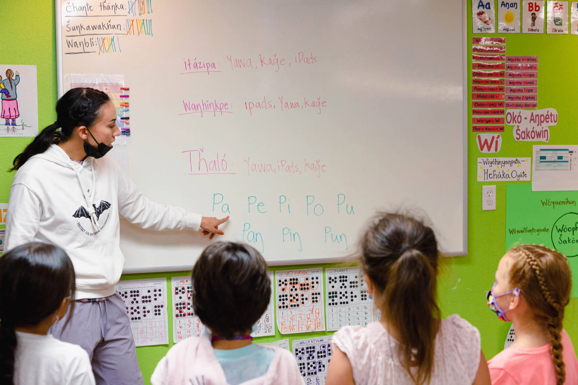Children practice their Lakota vowels during class