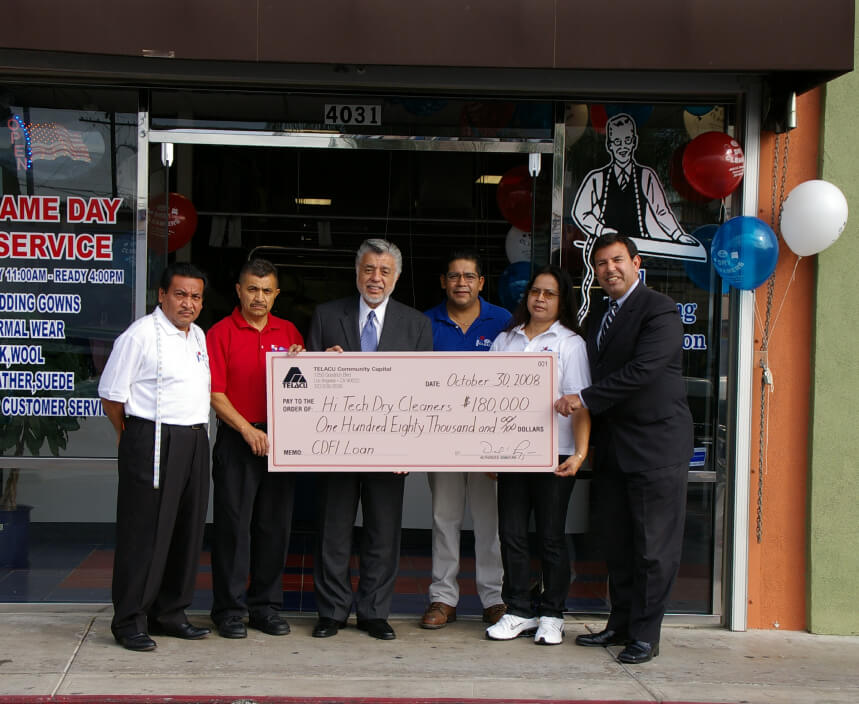 A photo of David Lizárraga standing with Hi Tech Dry Cleaners, beneficiaries of TELACU's work