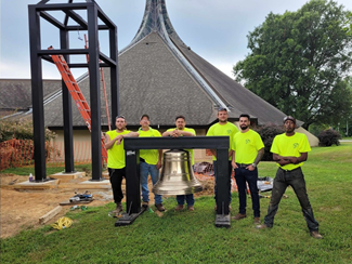 Photo of people standing behind a bell - Tri-State fabricated and donated this bell tower to Compassionate Friends, a charity that helps families who have lost loved ones through the grieving process.
