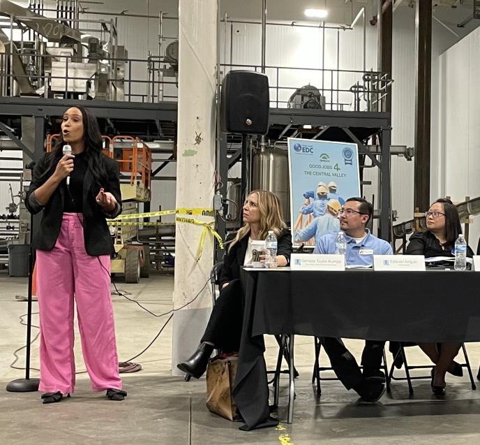 Photo of a woman speaking from EDA’s Manufacturing Community of Practice’s Roadshow convening with the San Joaquin Valley Manufacturers Association in August 2023