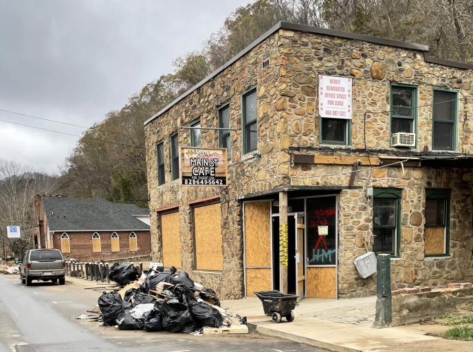 Photo of building with pile of debris in front of it on Mainstreet in Helene