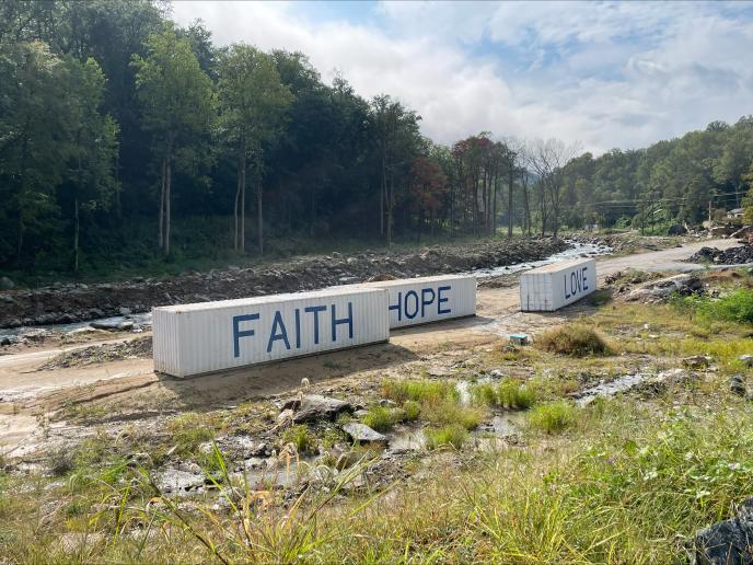 Photo of 3 shipping containers reading Faith, Hope and Love