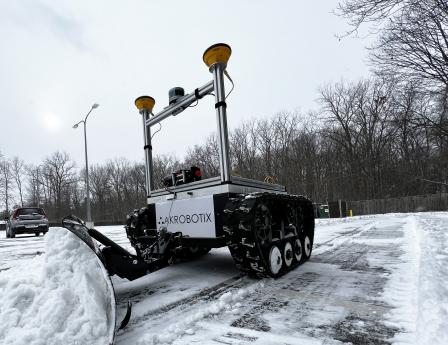 The Snowbotix autonomous snow removal machine removes snow in the parking lot of Lawrence Technological University. (Credit: Snowbotix)