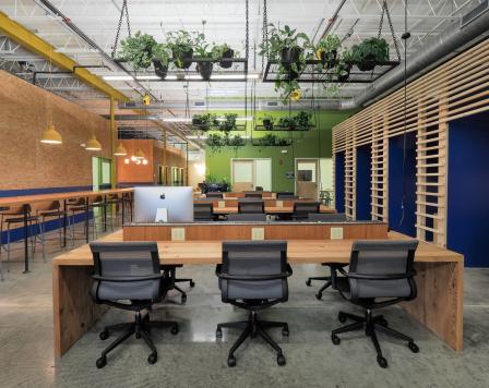 Picture of empty chairs by a desk.