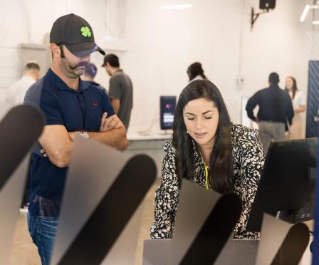 Photo of two BrainStation bootcamp students in the middle of hands-on instruction in a variety of tech fields, including AI.
