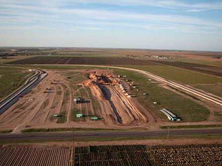 Workers construct new rail spur to facilitate shipping raw materials to manufacturing and distribution center.