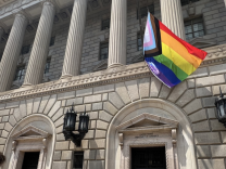 Image of the Progress Pride Flag flies in front of the Herbert Hoover Building, location of EDA headquarters, in 2022.